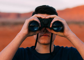 Executing the Job Search - picture of a man searching for something using binoculars